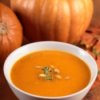 Pumpkin Soup with Pumpkins in the Background