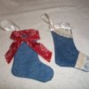 Two completed stockings, one with lace and one with bandana fabric.