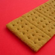 Graham cracker on a red background.