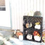 Decorative snails on plastic crates along with fall colored silk flowers.