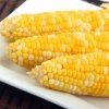 A plate of yellow corn on the cob.