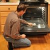 Man cleaning the oven.