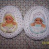 Two baby cradle church purses with Kewpie dolls inside.