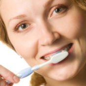 Woman brushing her teeth.