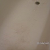 Hair dye stains in a bathtub.