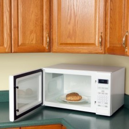 Potatoes on a plate in the microwave.