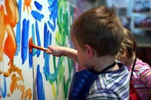 Photo of a kid finger painting.
