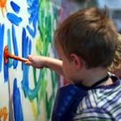 Photo of a kid finger painting.