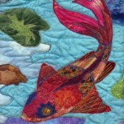 Up close photo of a colorful koi quilt.