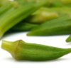 Small isolated okra with more in the background.