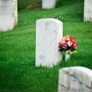 Saving Money on Funeral Expenses, A headstone at a cemetery.