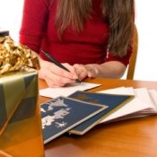 A woman filling out Christmas cards.