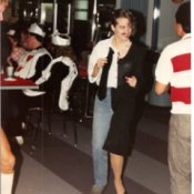 A halloween costume where the right side is a man in a white shirt, jeans and a tie, and the left is a woman in a black dress with heels.