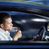 Man Lighting a Cigarette in his Car While Driving