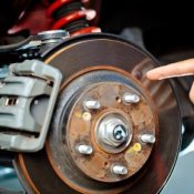 Man Pointing at Brake Rotor