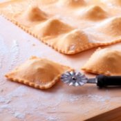 Homemade ravioli being cut apart.