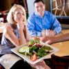 Couple being served a Salad