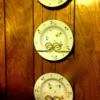 3 China plates hanging on wall in plate rack