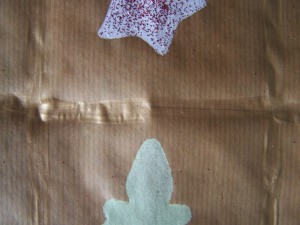 Paint golden lines in between the stars and trees.