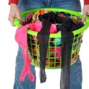 Woman carrying a laundry basket full of socks.