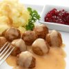 Plate of Swedish meatballs with mashed potatoes and lingonberry sauce.