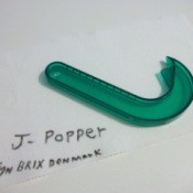 A green J-Popper kitchen tool for opening ring top cans.