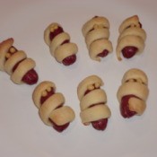 Croissant wrapped sausages as a Halloween appetizer.
