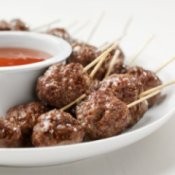 Meatballs on toothpicks with dipping sauce.