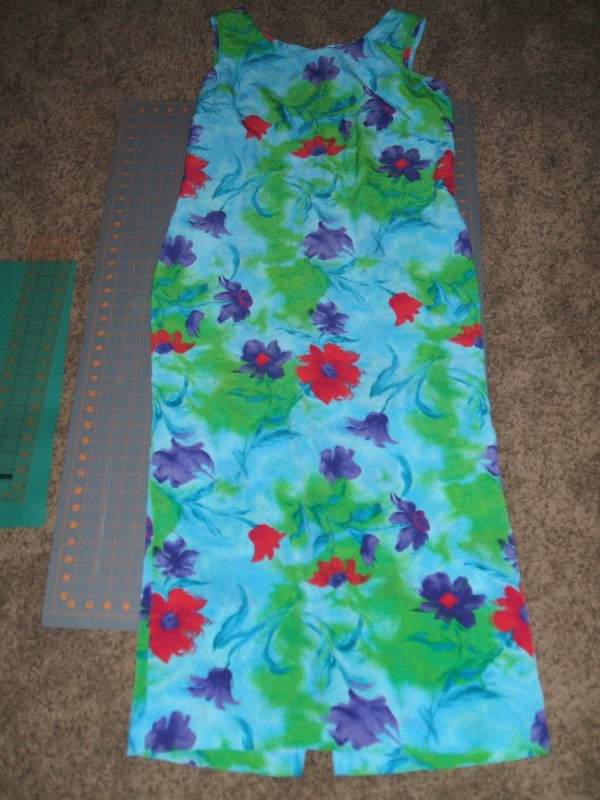 Long sleevelss aqua dress with green leaves, and pink and purple flower patterned all over.