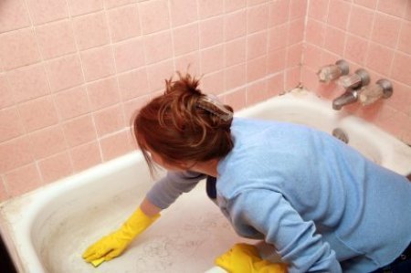 Woman Cleaning Bathtub
