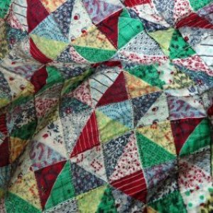 Image of vintage quilt composed of triangles.