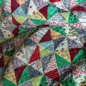 Image of vintage quilt composed of triangles.