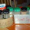 Photo of using recycled containers to organize spices.
