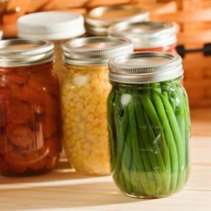 Canned green beans with other vegetables in background.