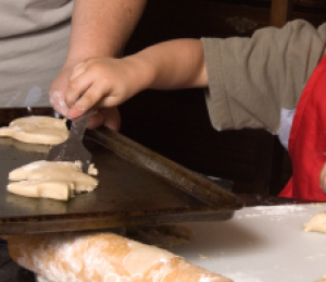 Photo of a kid making cookies.