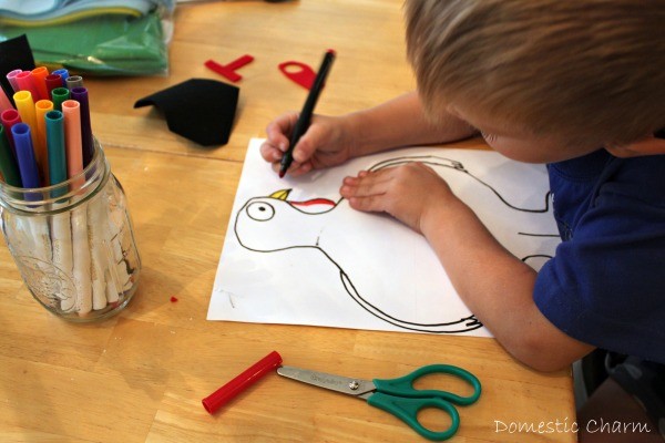 Young boy coloring turkey drawing in.