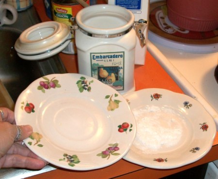 Two saucers with crushed sugar in the bottom one.