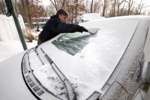 Keeping Your Windshield Free of Snow and Ice, Man Cleaning Snow and Ice off of Windshield