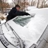 Keeping Your Windshield Free of Snow and Ice, Man Cleaning Snow and Ice off of Windshield