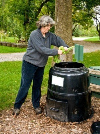 Picture of a woman using a composter.