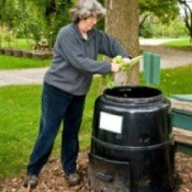 Picture of a woman using a composter.