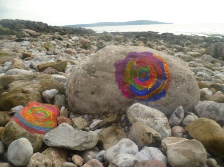 Colorful Spiral Painted on Large Rock on the Beach