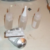 Small plastic bottles filled with craft glue.