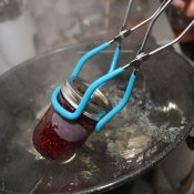 Canning Raspberries, Raspberry Jam Recipes. Canning Tips and Tricks. Jar of Jam Being Pulled from Canner