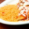 Plate of Spanish rice with enchiladas.