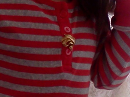 An earring as a decoration on a sweater