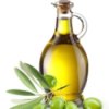 Bottle of olive oil with olives and leaves in the foreground.