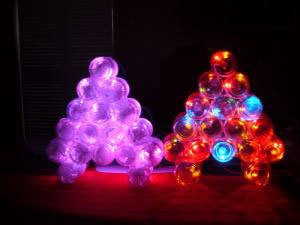 Photo of a lit Christmas tree made with baby food jars.