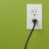 An electrical cord plugged into an outlet.