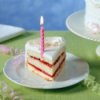A slice of birthday cake with a half candle.
